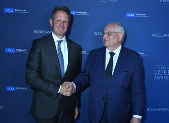 Timothy Geithner, 75th U.S. Secretary of the Treasury, congratulates Martin Wolf of the Financial Times, 2019 Loeb Lifetime Achievement Award, after presenting him with his award.