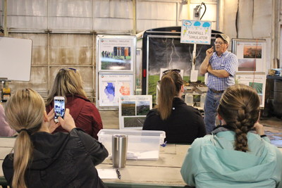 During a tour of his farm in Esmond, Illinois, Paul Taylor helped explain a rainfall simulator to show dieticians and health professionals how different agronomic practices impact soil health and runoff.