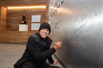 Smokey Robinson signs the autograph wall during his special visit with patients at St. Jude Children’s Research Hospital in Memphis, Tennessee.