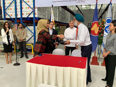 AHA Centre Executive Director Adelina Kamal (center left) and Direct Relief's Executive Vice President and Chief Operating Officer Bhupi Singh formally inaugurate a newly completed warehouse in the Philippines on July 1, 2019. The warehouse, completed with funding from Direct Relief, will expand disaster response in the region. (Direct Relief photo)