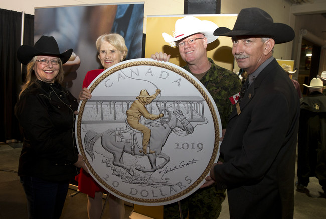 From left: Artist Michelle Grant, Chair of the Royal Canadian Mint's Board of Directors.  Phyllis Clark, Brigadier-General Stephen Lacroix and Calgary Stampede President and CEO Warren Connell unveil a silver coin marking the 100th anniversary of the Stampede of Victory in Calgary (July 4, 2019).  (CNW Group / Royal Canadian Mint)