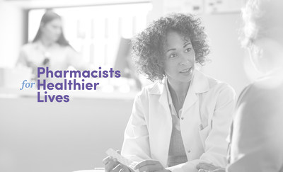 A female pharmacist sits with a senior female patient in the pharmacist consultation area and discusses her prescription and choice of medication. In the background a father and daughter stand at the dispensing counter and are served by a female pharmacy assistant.