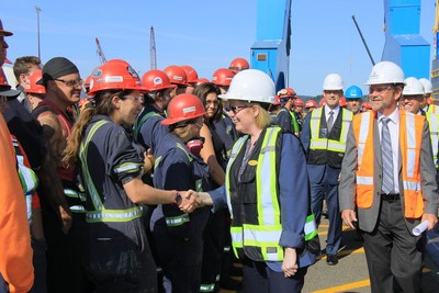 The Honourable Carla Qualtrough, Minister of Public Services and Procurement and Accessibility, greets trades workers with Joe O’Rourke, Vice President and General Manager, Seaspan Victoria Shipyards. (CNW Group/Seaspan Shipyards)