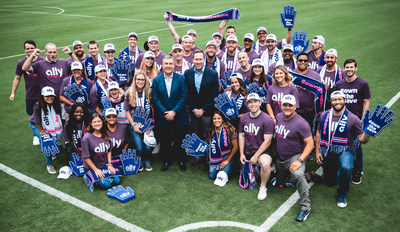 An excited group of employees gather around Ally Financial CEO, Jeffrey Brown (left) and Tom Glick (right), leader of the Charlotte Bid Team Friday after they announced a multi-year agreement. The agreement names Ally the founding and lead partner of a potential Major League Soccer team in Charlotte and the Carolinas.