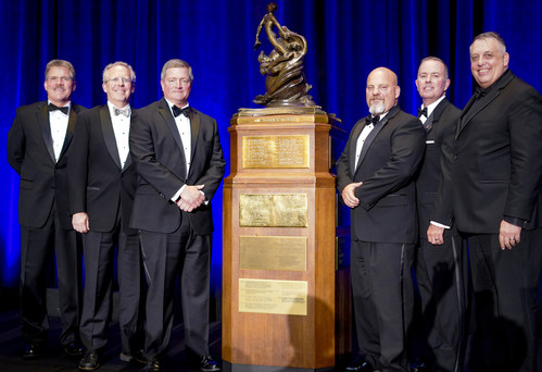 DCS employee-owners pose with the Collier Trophy. Mark Wilkins (third from left) and Finley Barfield (not pictured) are key members of the winning AGCAS Team.