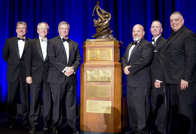 DCS employee-owners pose with the Collier Trophy. Mark Wilkins (third from left) and Finley Barfield (not pictured) are key members of the winning AGCAS Team.