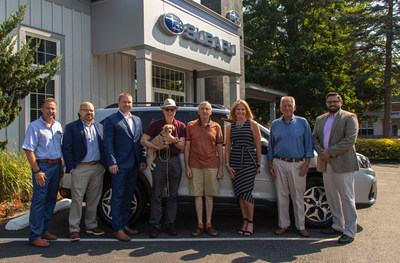 Subaru of America sells two-millionth Forester in the U.S. (L to R) Scott Hutchins (CFO), Joe Monaco (sales & marketing director), Chris Peterson (sales consultant), Brian Gerber (new Forester owner), John Reeser (customer), Kristin Hutchins (retailer president), Lewis Ruge (founder), Chris Sherman (sales manager)