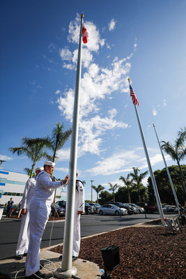 U.S. Navy Fleet Ballistic Program representatives raise Florida's flag at a new headquarters shared with Lockheed Martin in Titusville, Florida.