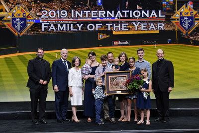 Joseph and Nicole Krebs of Albany, Ore, center, and their eight children are joined by Knights of Columbus Supreme Knight Carl Anderson and his wife, Dorian (both to the left), after receiving the organization's 2019 Family of the Year Award at the Knights' 137th International Convention in Minneapolis. Archbishop William Lori of Baltimore, the K of C supreme chaplain, is pictured at right and Father Theodore Lange, the Knights' Oregon state chaplain, is at left.