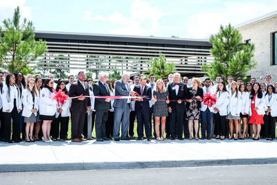 Flanked by medical students, PCOM President and CEO Jay Feldstein, DO, and Georgia Governor Brian Kemp with First Lady Marty Kemp and PCOM Board Chair John Kearney, lead the ribbon cutting which marks the opening of PCOM South Georgia, the first four year medical school in Southwest Georgia.