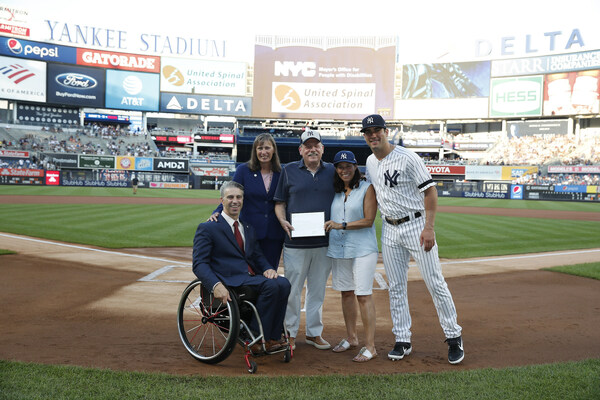 Left to right: Victor Calise, Commissioner, Mayor's Office for People with Disabilities; Kleo King, Deputy Commissioner & General Counsel, Mayor's Office for People with Disabilities; James Weisman, president & CEO, United Spinal Association; Holly Weisman; and Mike Tauchman, New York Yankees outfielder (PHOTO CREDIT: NEW YORK YANKEES. ALL RIGHTS RESERVED. © NEW YORK YANKEES)