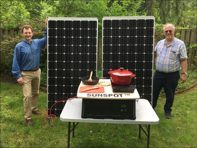 Paul Carroll and Douglas Danley (right) stand alongside the Sunspot Solar Electric Cooker. Danley, Carroll and team members Teresa Danley, and Vladimir Brunstein (not pictured) were this year's winners of the Elsevier-ISES Renewable Transformation Challenge (Credit: Douglas Danley).