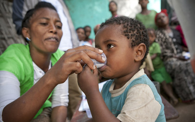 Ethiopia, Kambata, Alaba, Tembaro Zone (KAT) - Kadida Gamela Woreda, Adilo Village -A child receives a dosage of Zithromax. Photograph by Geoff Oliver Bugbee Ethiopia, Kambata, Alaba, Tembaro Zone (KAT) - Kadida Gamela Woreda, Adilo Village -A child receives a dosage of Zithromax. Photograph by Geoff Oliver Bugbee