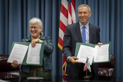 IFYE President Victoria Warren, left, and Deputy Secretary of Agriculture, Stephen Censky hold signed copies of a memorandum of understanding between the two organizations from a ceremony held earlier today.