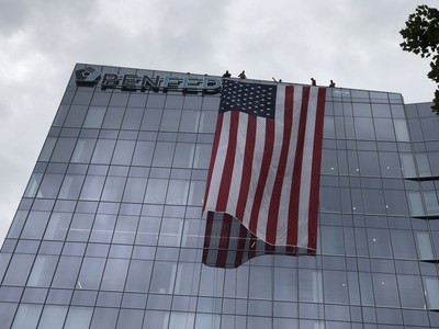 A large American flag drapes over PenFed’s corporate headquarters in Tysons, Virginia in honor of American heroes during the terrorist attacks of September 11, 2001.