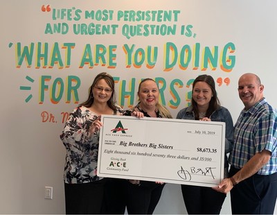 ACE Cash Express associates present their donation to Julia Kelley, Engagement Manager for Big Brothers Big Sisters Lone Star