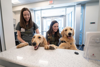 St. Jude Child Life specialists Shandra Taylor (left) and Brittany Reed
will be the primary handlers for Huckleberry, a Golden Doodle, and Puggle, a Golden Retriever. The St. Jude Paws at Play hospital dogs will assist in distracting pediatric patients from their illness, symptoms, pain and anxiety. They will also motivate and support patients through social interaction. St. Jude Child Life specialists Shandra Taylor (left) and Brittany Reed
will be the primary handlers for Huckleberry, a Golden Doodle, and Puggle, a Golden Retriever. The St. Jude Paws at Play hospital dogs will assist in distracting pediatric patients from their illness, symptoms, pain and anxiety. They will also motivate and support patients through social interaction.