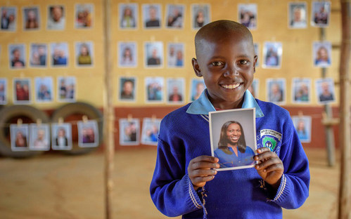 Mary, 8, from Kenya, smiles as she holds the photo of the sponsor she chose. “I picked the beautiful one,” she said. (CNW Group/World Vision Canada)